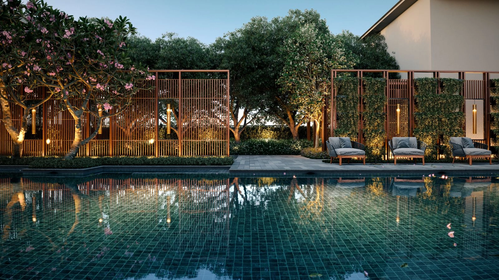 111 Menerung pool deck lounge seating at twilight with timber screen wall and mature frangipani trees in Bangsar, Kuala Lumpur