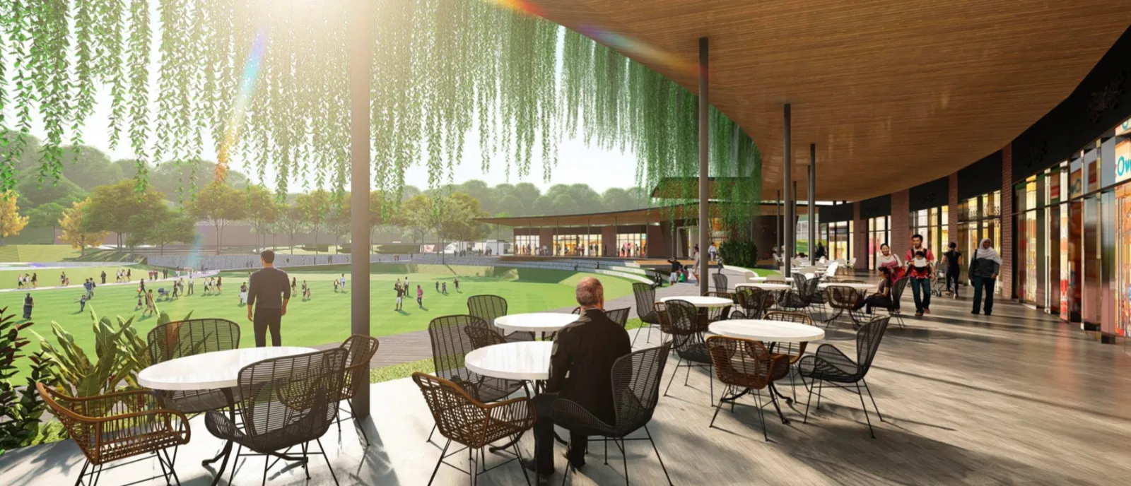 Dek makan al fresco Townpark Bandar Tiram menghadap padang hijau terbuka dalam township JLG