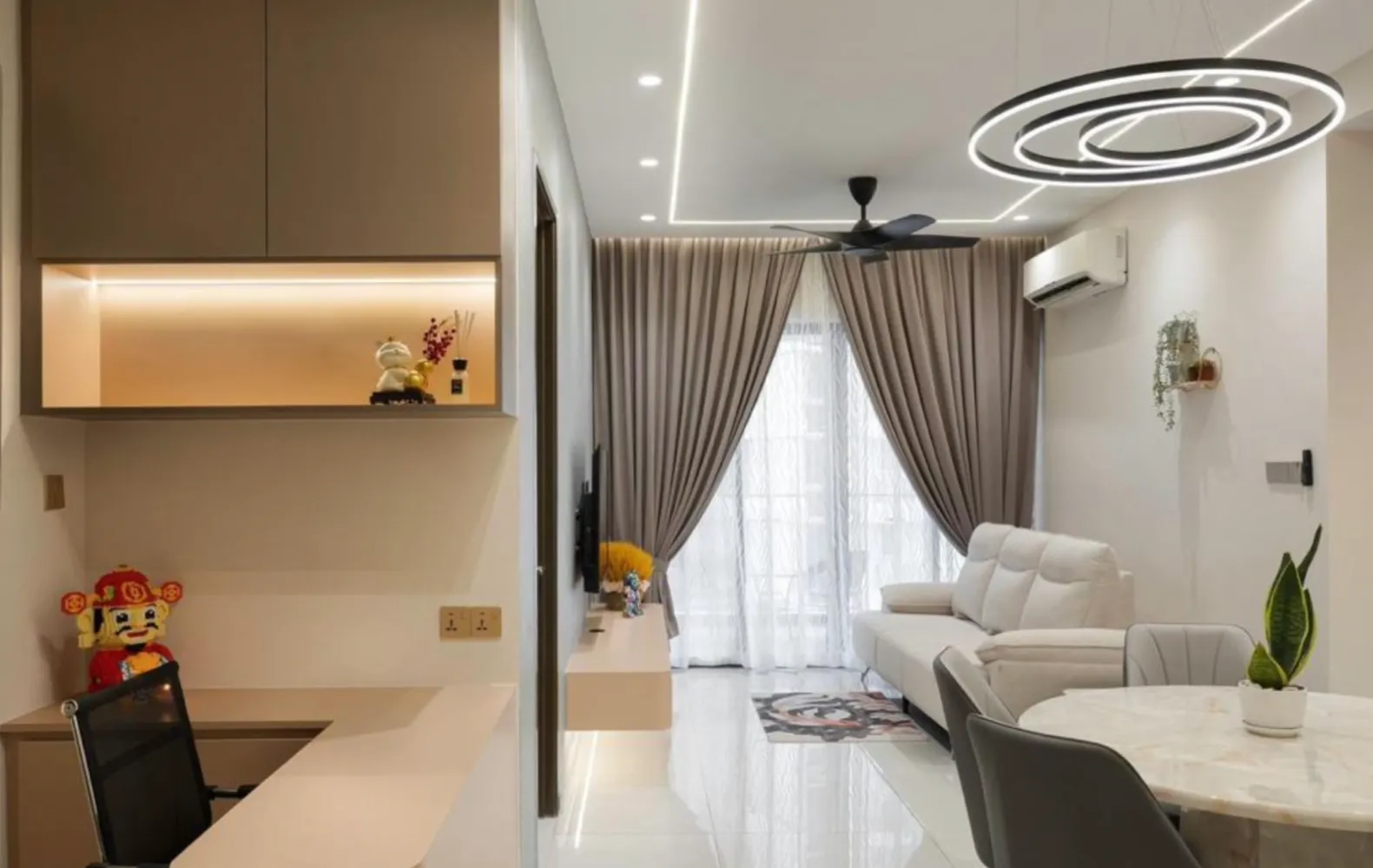 Open-plan living room interior with plush sofa and balcony curtain windows at Country Garden Danga Bay in Danga Bay, Johor Bahru, Johor