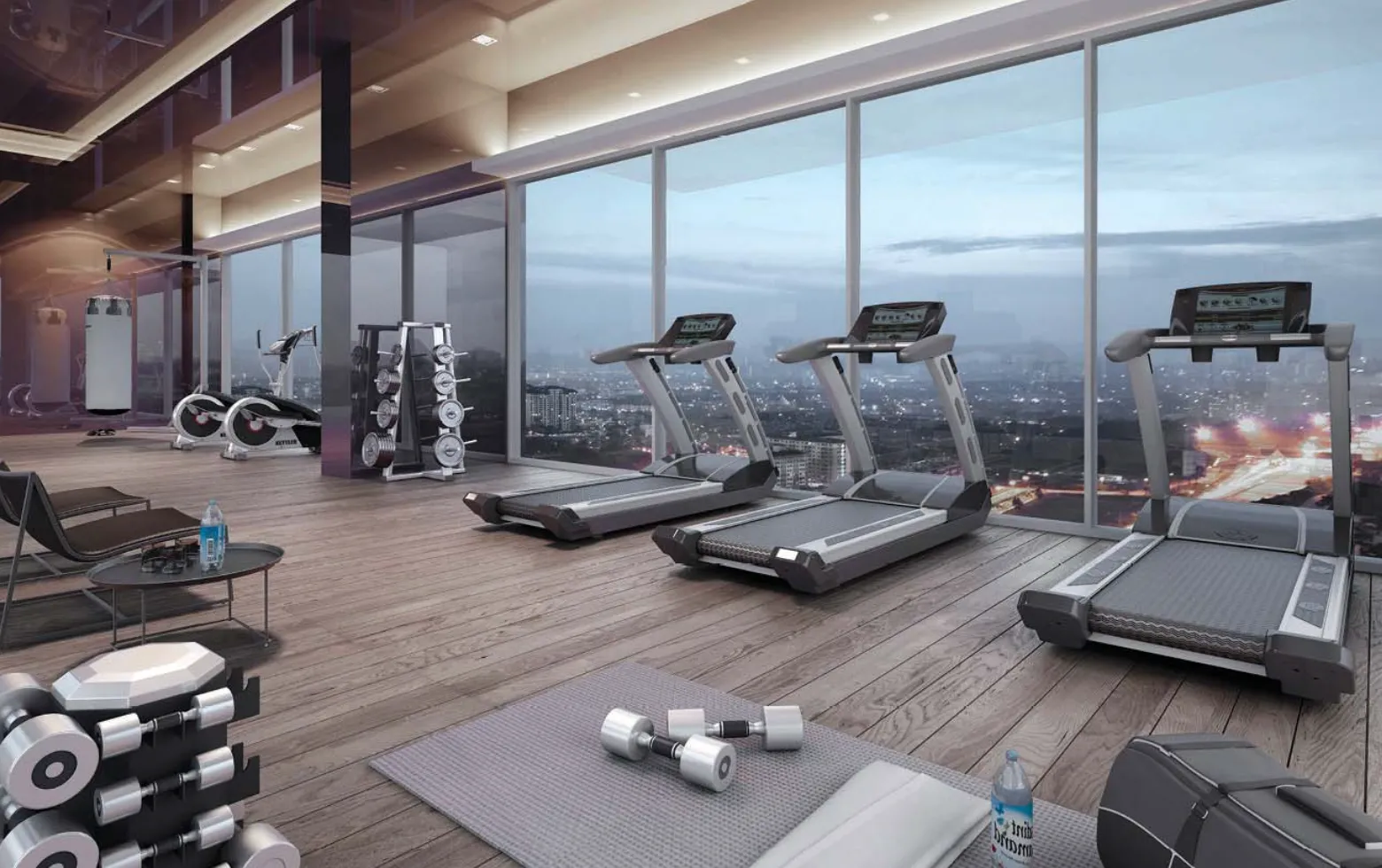 Gim langit berdinding kaca di Elysia Park Residence dengan treadmill dan alat berat bebas menghadap skyline Iskandar Puteri