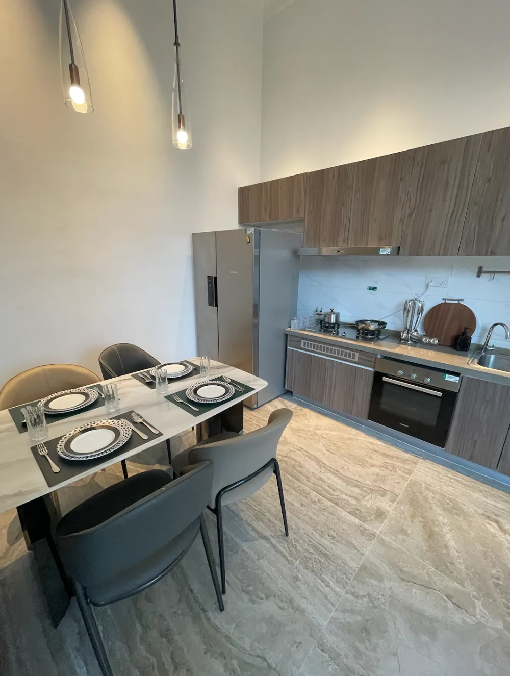 Forest City Golf Villa (Garden Terrace) Forest City Golf Villa show villa dining table and open kitchen with built-in oven and hob in Forest City Golf Resort, Gelang Patah, Johor