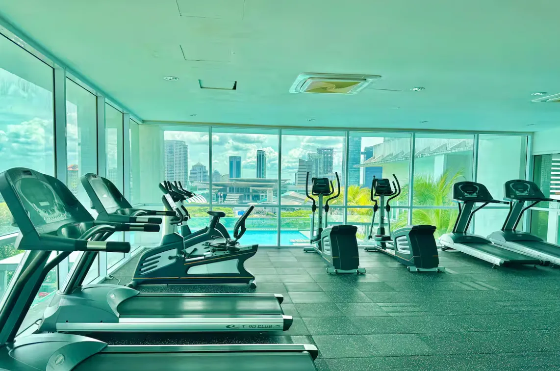 Paragon Suites @ CIQ gymnasium treadmill row with a view over the rooftop swimming pool in Stulang Laut, Johor Bahru City Centre, Johor