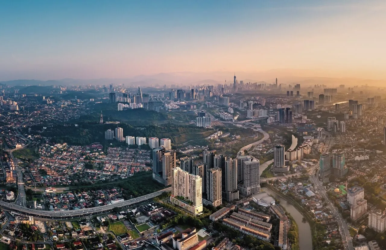 Aerial dusk view of the Kuala Lumpur city skyline near Old Klang Road, the surrounding neighbourhood of Radium Arena