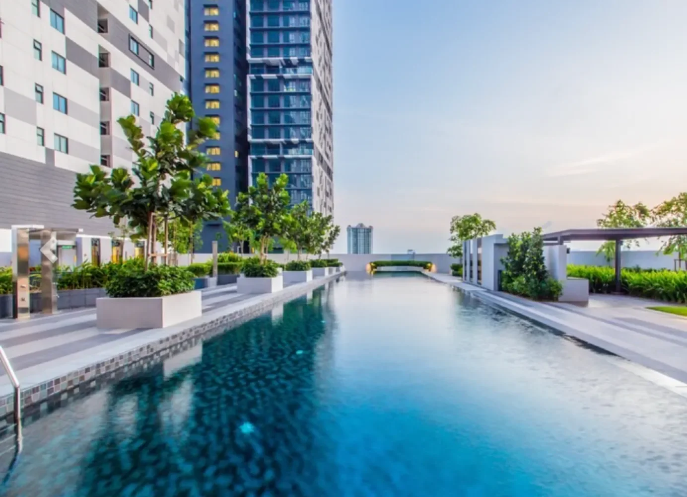 Dek kolam renang atas bumbung Setia Sky 88 pada waktu senja dengan pemandangan panorama Johor Bahru