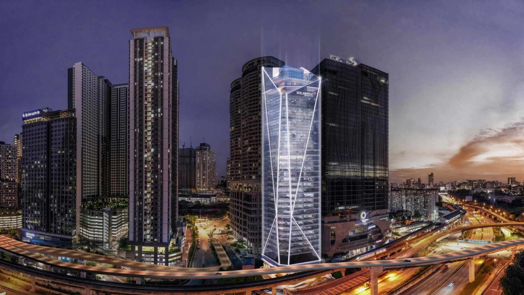 Menara pejabat Solarvest Suites bercahaya pada waktu malam di atas Lebuhraya Federal dan viaduk LRT Kelana Jaya di Bangsar South