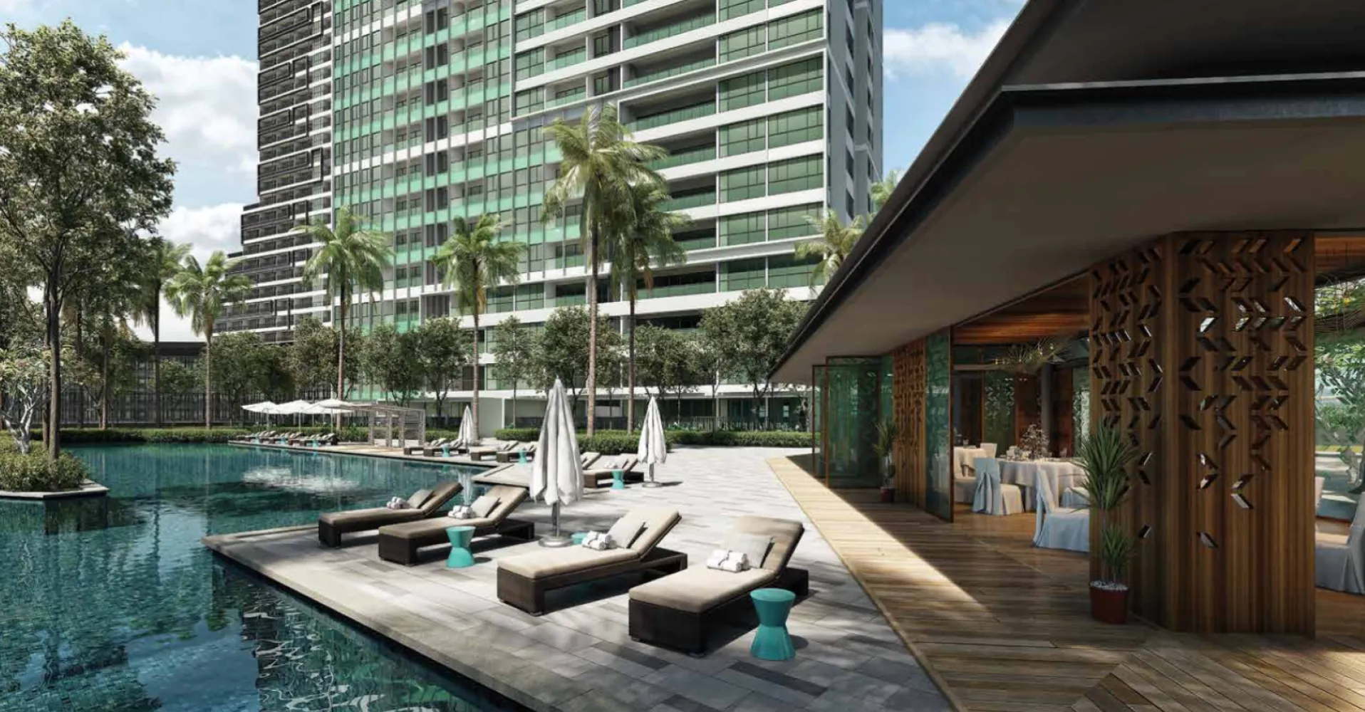 Dek kolam renang 50 meter Southern Marina Residences dengan kabana tepi kolam dan pavilion makan tepi marina