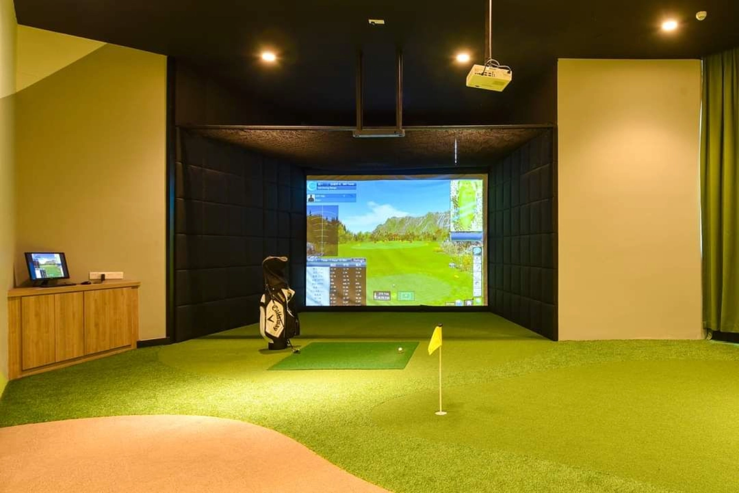 The M Macrolink Medini indoor golf simulator room with putting green and screen in Medini, Iskandar Puteri, Johor