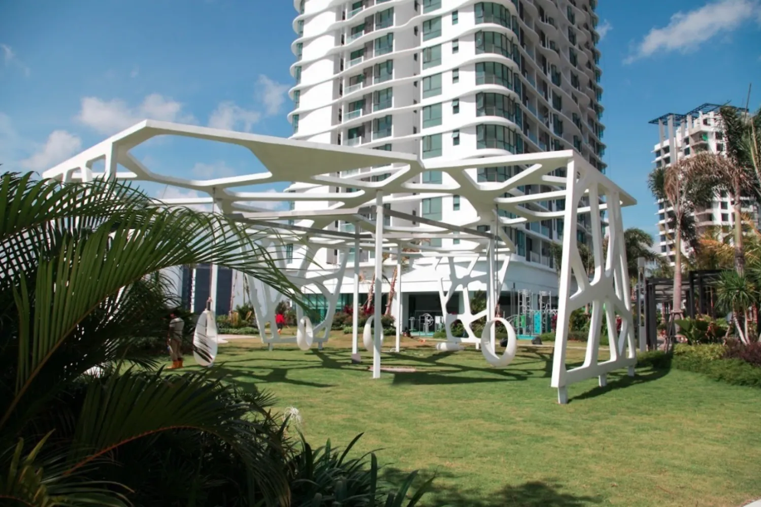 The M Macrolink Medini sculptural outdoor play structure with swings on the facilities lawn in Medini, Iskandar Puteri, Johor