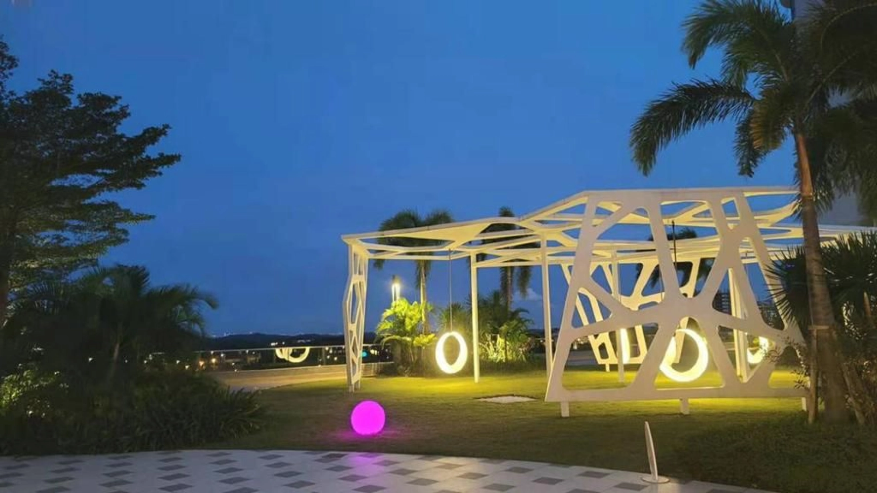 The M Macrolink Medini pool lounge deck illuminated at night with a moon sculpture feature in Medini, Iskandar Puteri, Johor