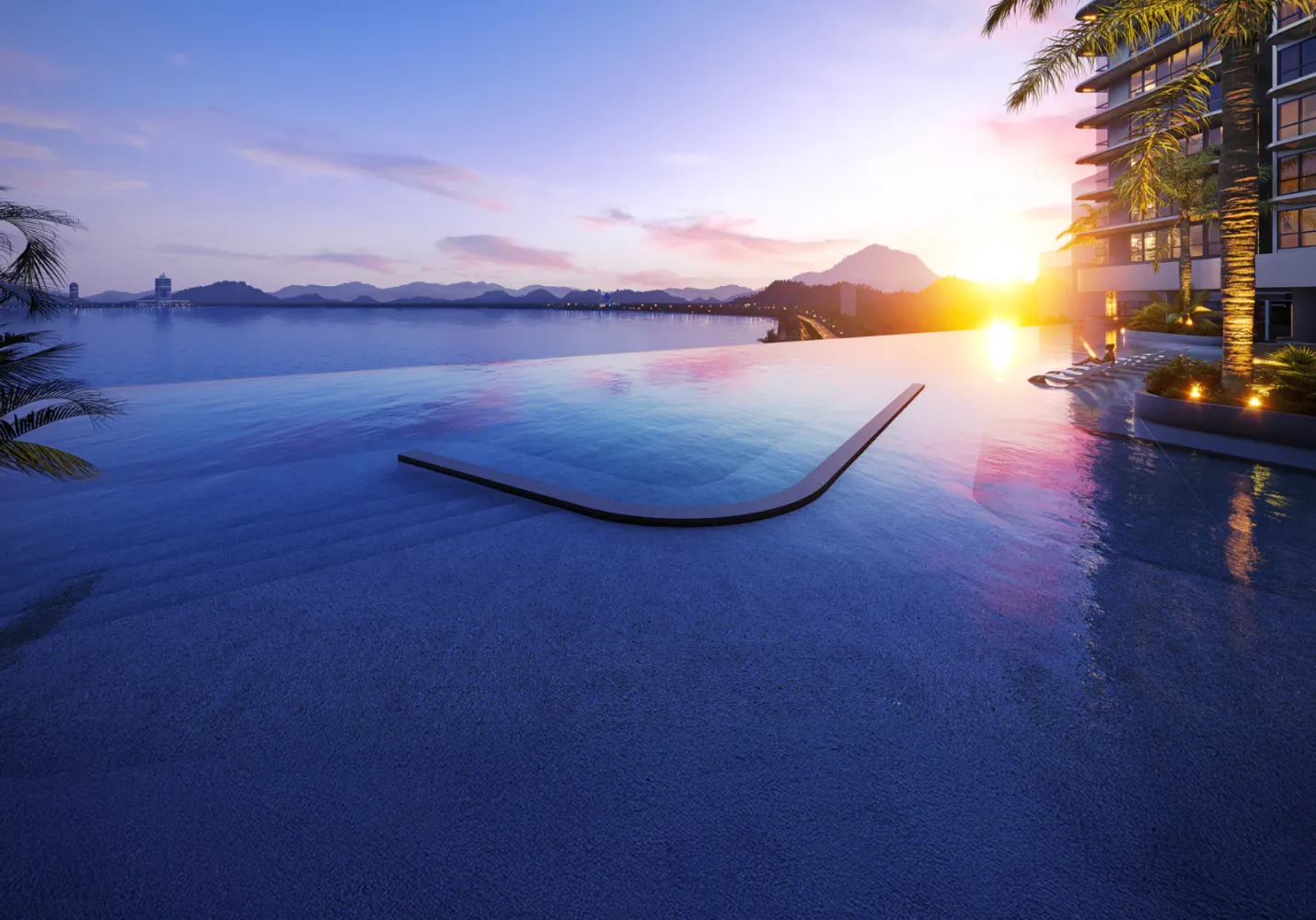 The V by Jesselton infinity pool deck at sunset overlooking Likas Bay's coastline and hills in Likas Bay, Kota Kinabalu, Sabah