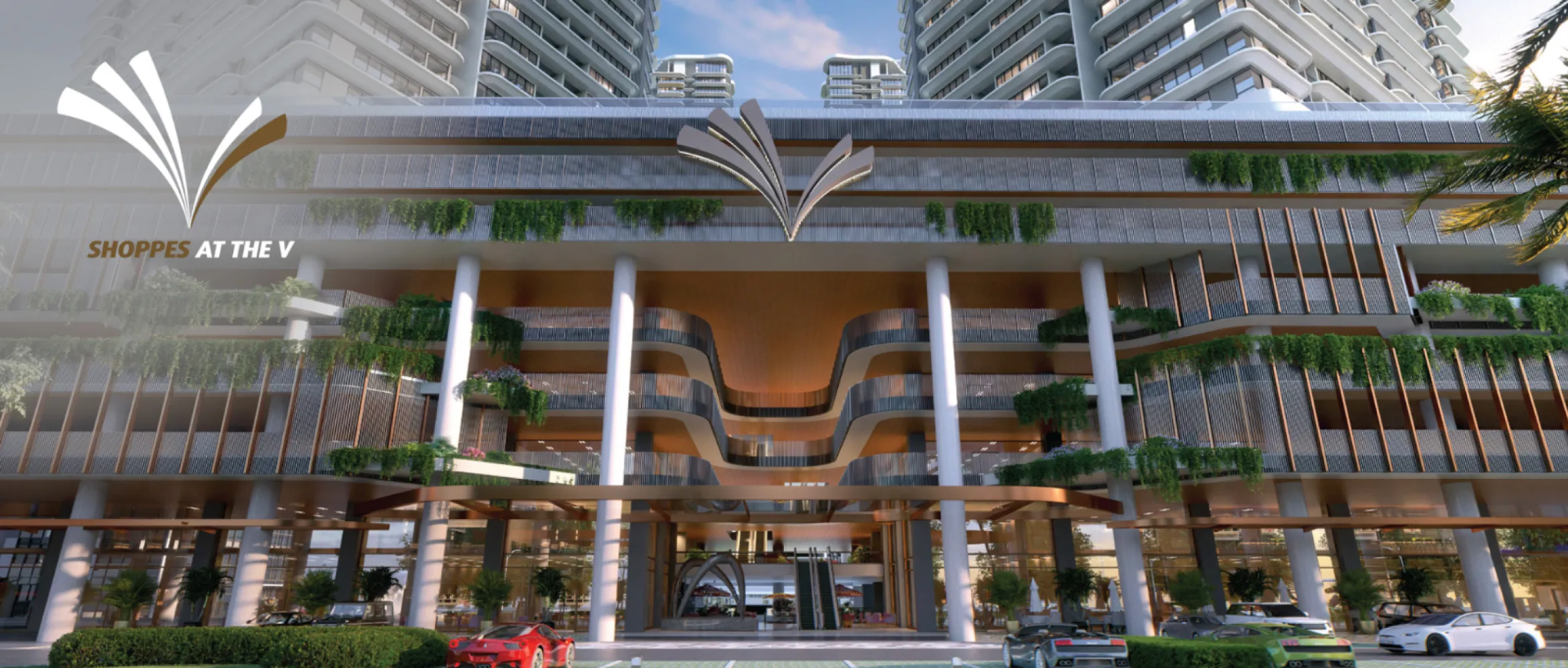 The V by Jesselton Shoppes at The V retail podium facade with the development's V-shaped logo and street-level dining in Likas Bay, Kota Kinabalu, Sabah