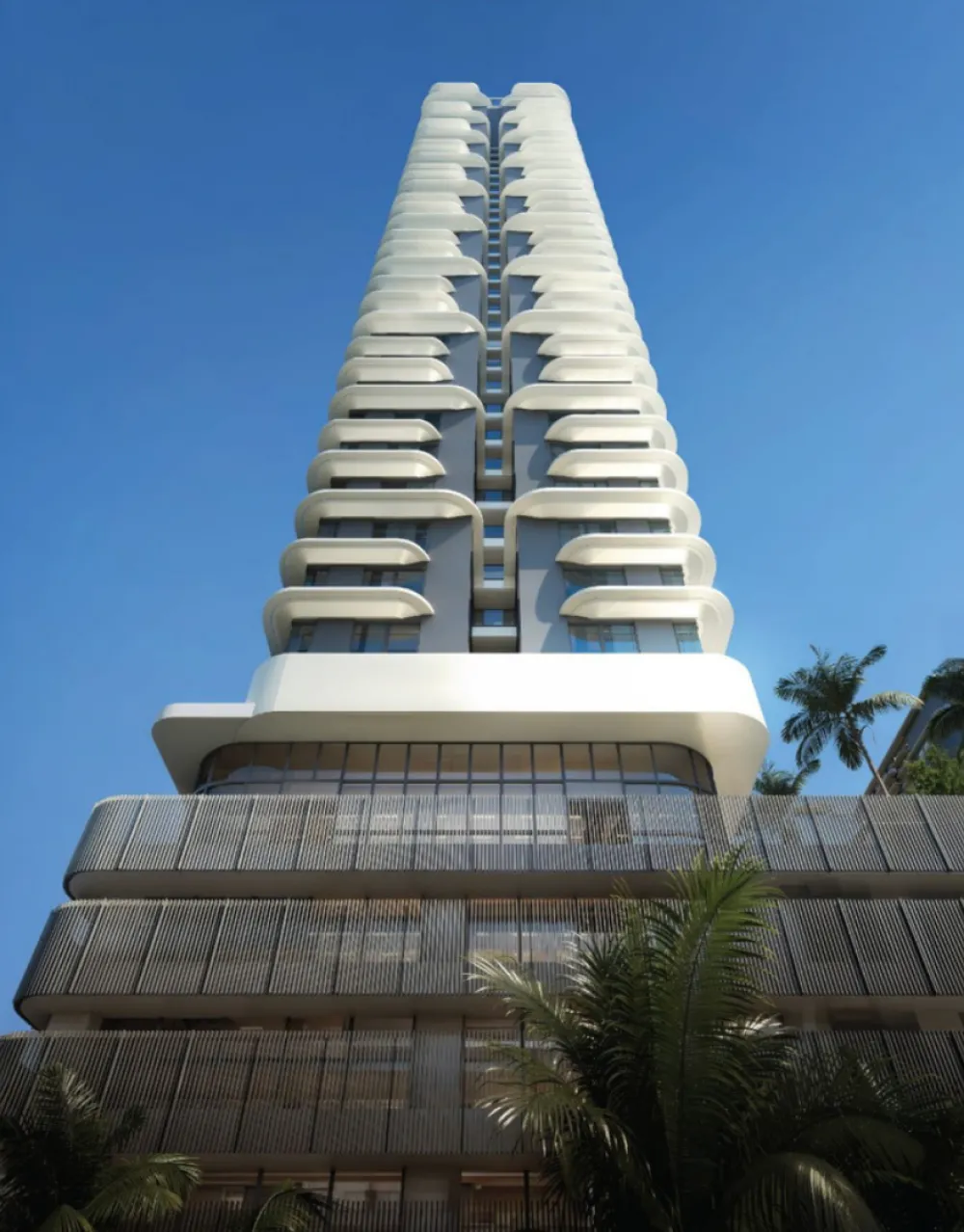 The V by Jesselton upward view of a residential tower facade showing curved balconies and full-height glazing in Likas Bay, Kota Kinabalu, Sabah