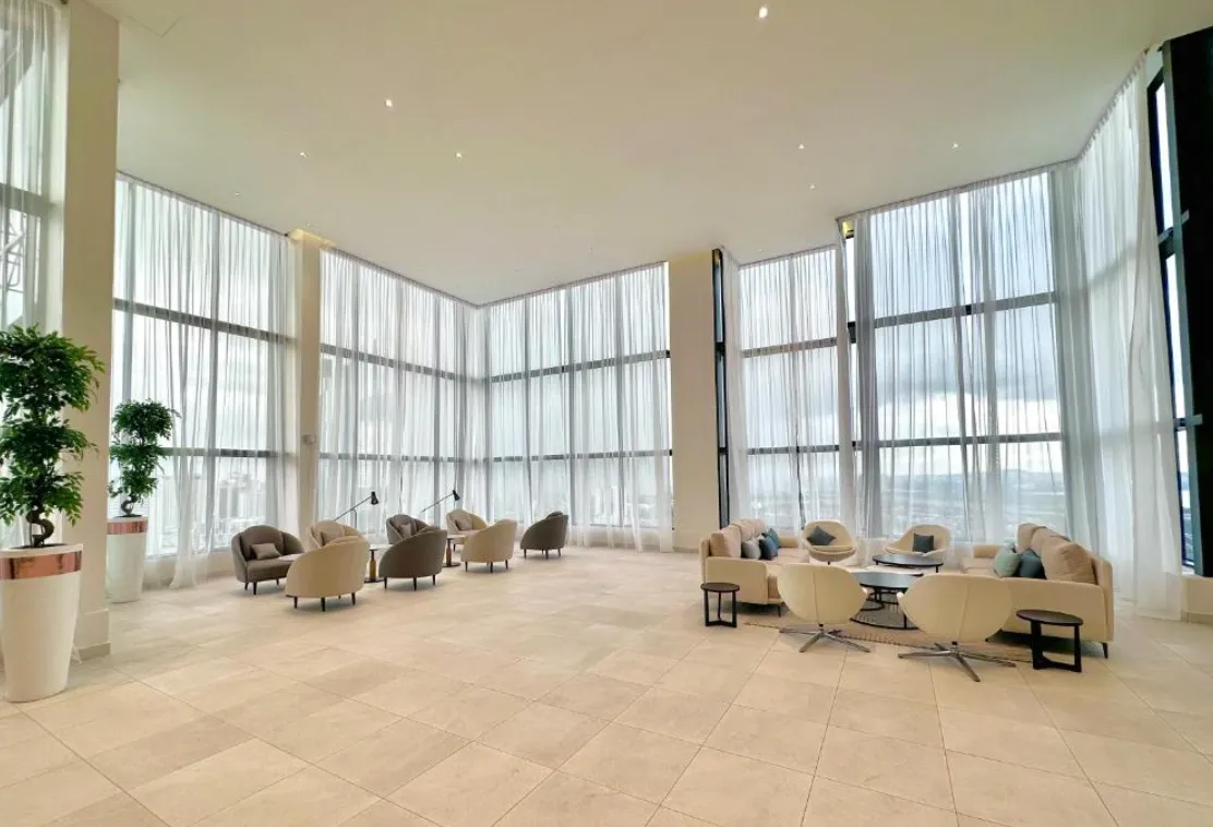 Twin Tower Residence lounge seating area beside full-height windows, Johor Bahru in Bukit Chagar, Johor Bahru, Johor